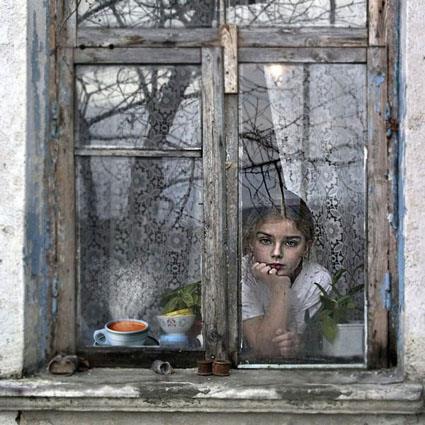 Young girl looking out the window